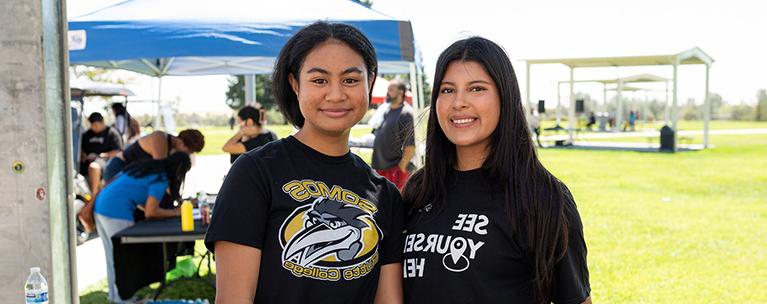 Two Butte College Studens are shown smiling on campus.